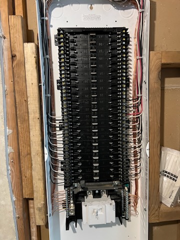 A full residential load center with branch circuits dressed in neat rows and every conductor landed