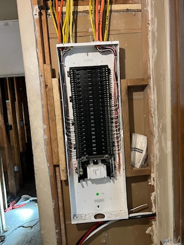 New panel set into open framing with home-run circuits dropped in during a residential rewire